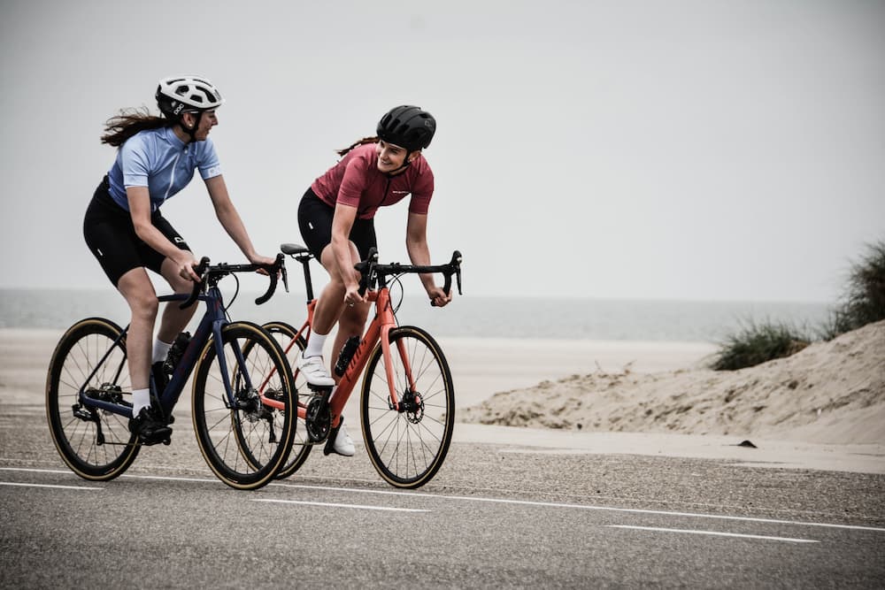 two women on sport bikes riding near along the beach