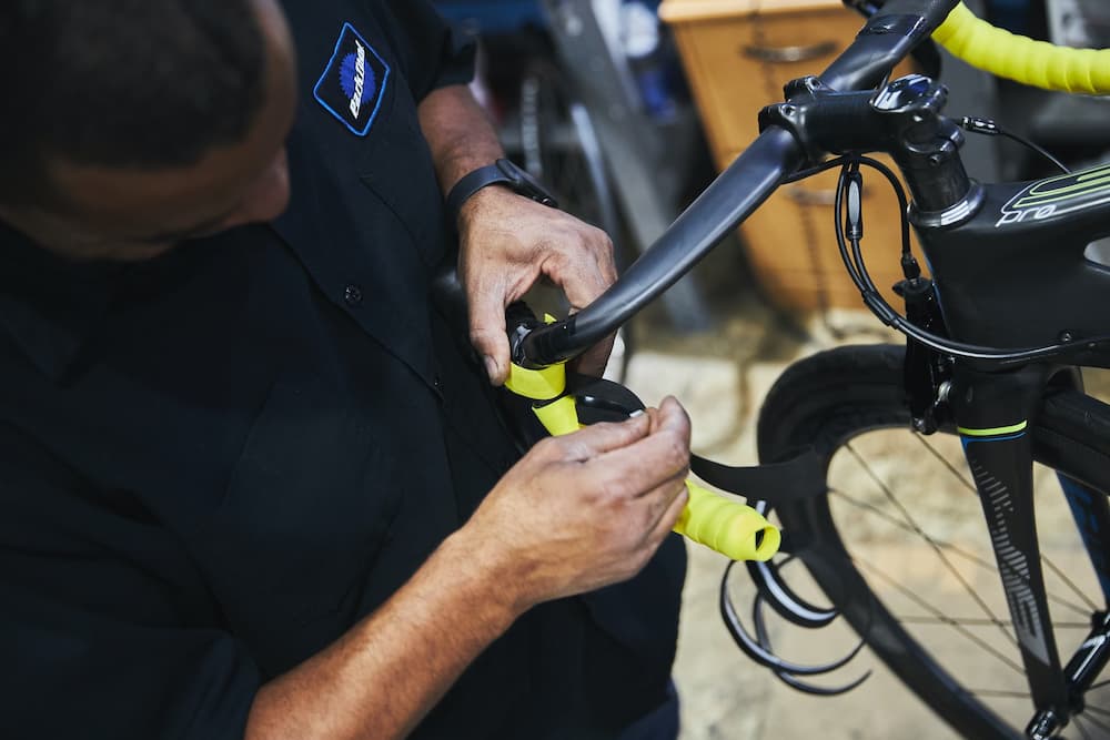 bike mechanic working on bicycle