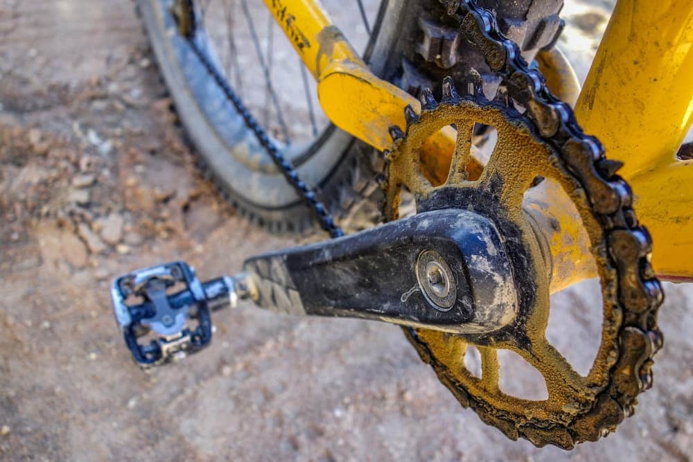 yellow bicycle with dirty chain