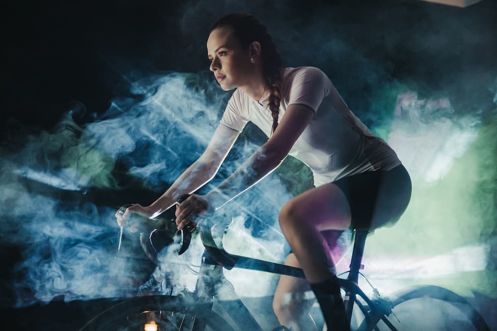 young woman wearing Munbaik indoor cycling clothing