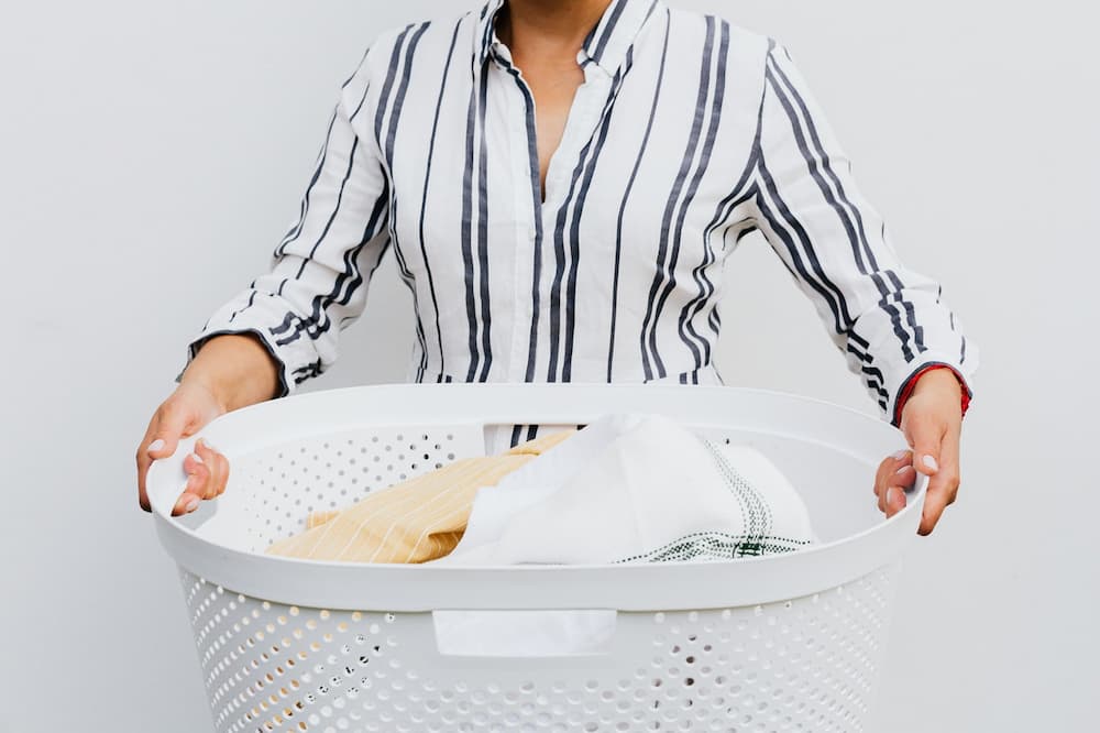 female cyclist carrying laundry basket