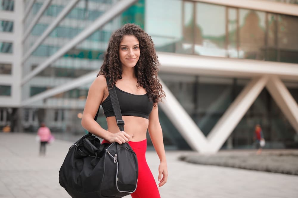 female cyclist with gym bag