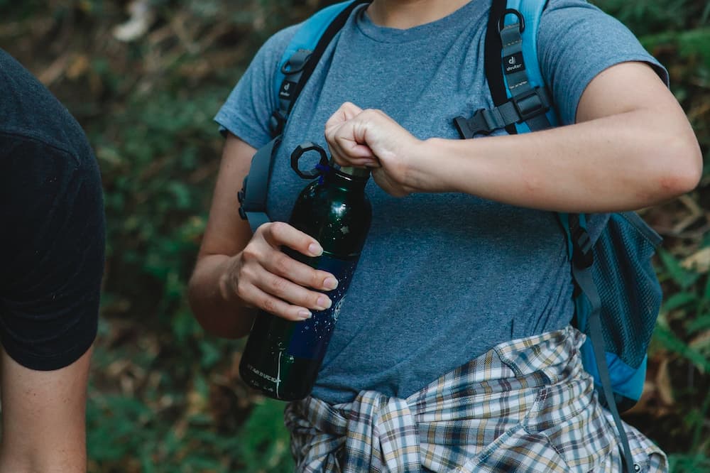 female cyclist holding drinking bottle