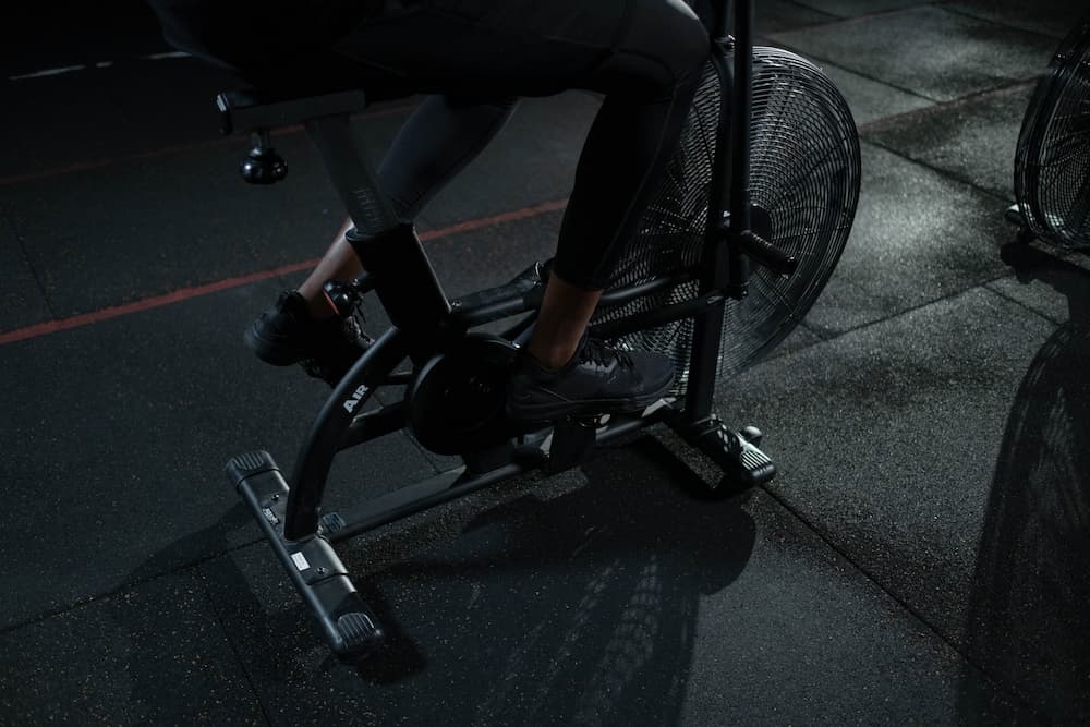 person working out on spin bike without mat underneath
